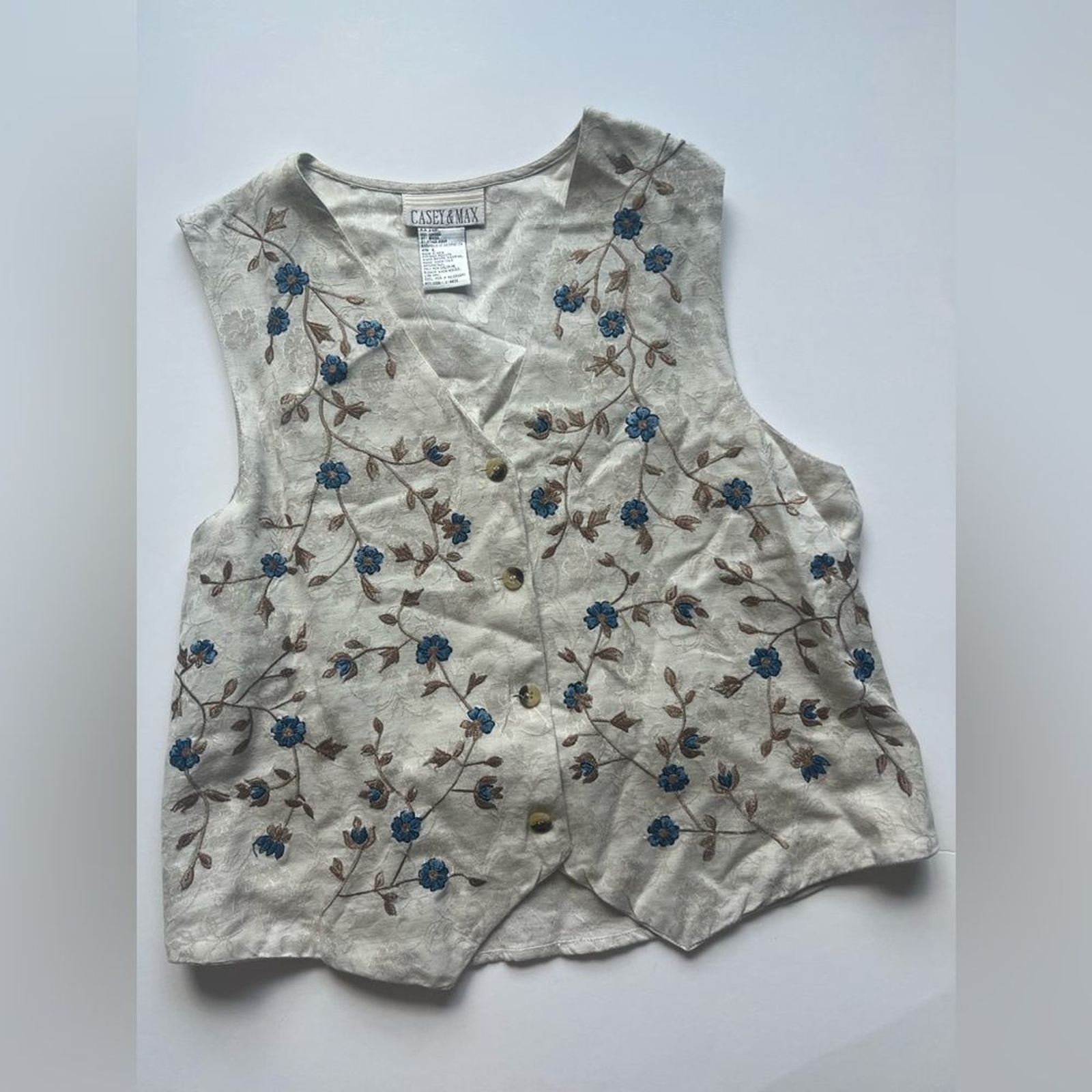 Cream Buttoned Embroidered Cotton and Rayon blend Vest with blue floral ornament